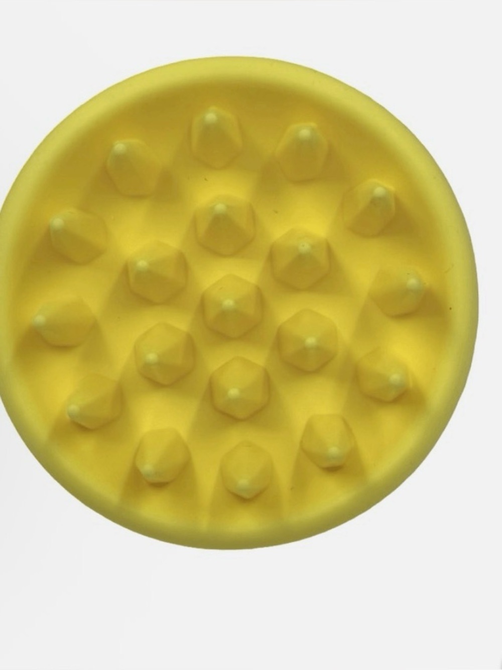 yellow Drybar silicone scalp massager scrubber.